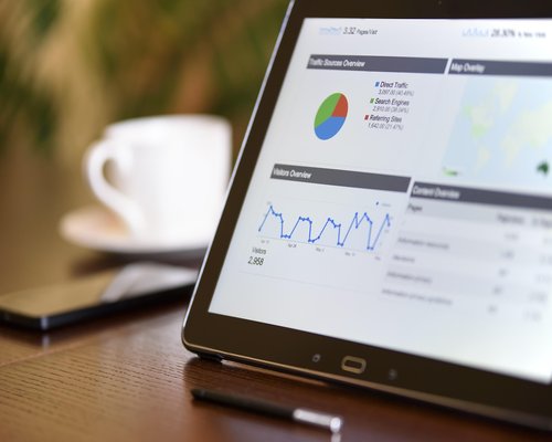Data researchers examining charts and analytics on digital displays