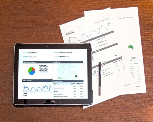 Educational charts, graphs, and research documents on a digital tablet